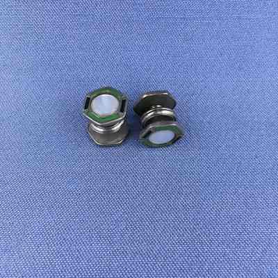 Cuffling-stud with mother-of-pearl button and green and black enameling, c, 1920s