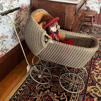 Wicker doll carriage with tan corduroy hood and sides, c. 1930