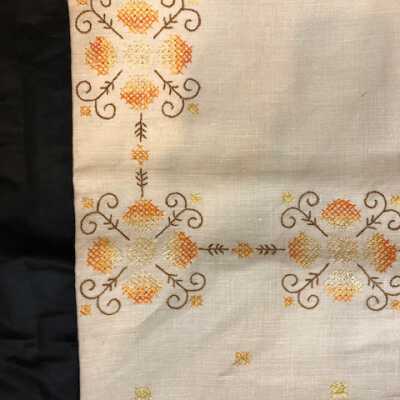 Ecru linen tablecloth with embroidered brown, orange and yellow flowers, c. 1930s