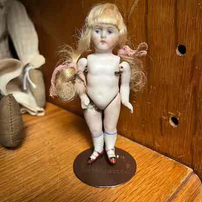 Blonde German bisque doll with painted stockings and shoes, early 1900s