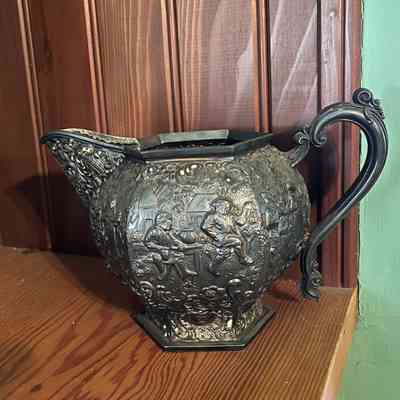 Silver plated pitcher with repousse of Dutch peasants, c. 1920s