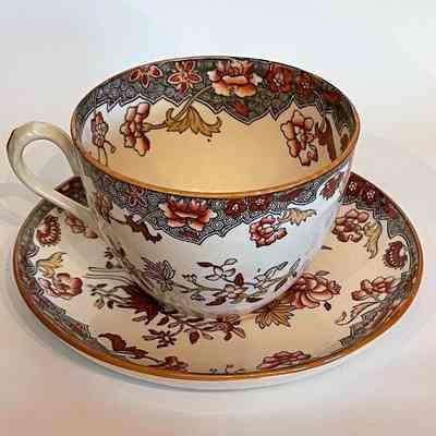 Porcelain cup and saucer with rust-colored flowers, c. 1890s-early 1900s