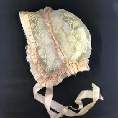 Ecru bonnet with grapes and leaves embroidery and pink lining, c. 1900