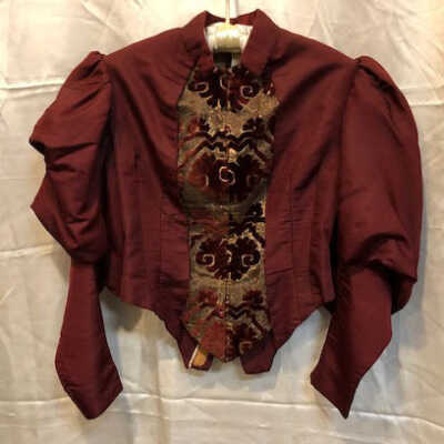 Day dress of maroon silk faille with mutton sleeves, c. 1890s