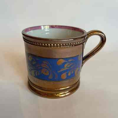 Child's mug in English copper luster with blue band, mid 19th century