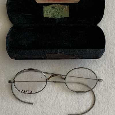 Eyeglasses & dark green imitation leather case from Shultz - Alameda's Optician, c. 1920s