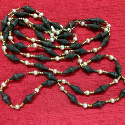 Opera length necklace of black composition beads, steel cuts, and pearls, early 1900