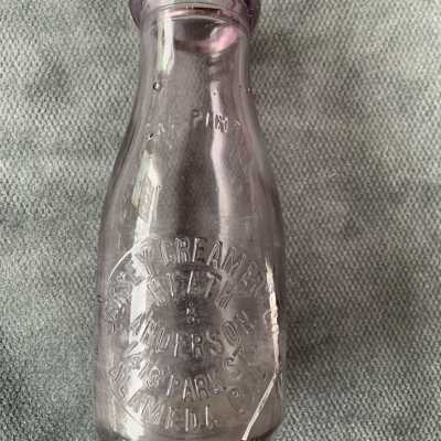 Lavender discolored pint bottle from Jersey Creamery Co., prior 1918
