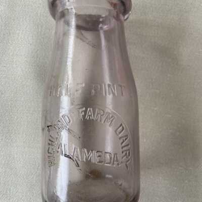 Half-pint lavender glass bottle from Highland Farm Dairy, 1910-1922