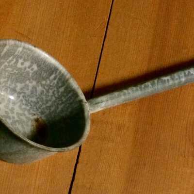 Graniteware ladle with oblong handle pierced for hanging, c. 1920