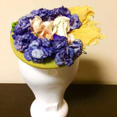 Hat of chartreuse straw with flowers and gold colored feathers, c. 1940