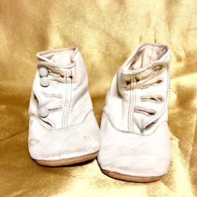 White kid baby shoes with brown leather soles, c. early 1900s