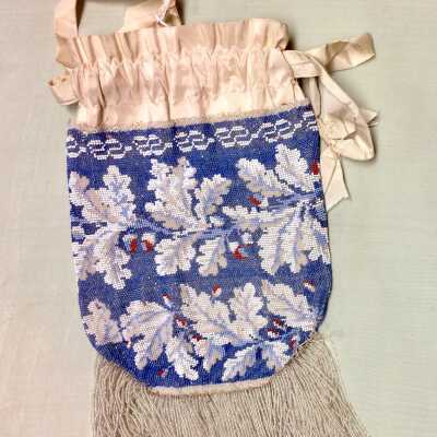 Beaded purse with acorn pattern and ties of white silk and beaded fringe, c. 1870s