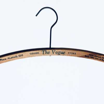 Wooden hanger advertising The Vogue Cleaners and Dyers, prior 1970