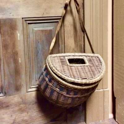 Half circular rattan and bamboo fishing creel with leather and canvas straps, c. 1920