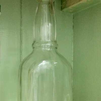 Clear glass bottle without label, by Ar. Winarick, Inc.