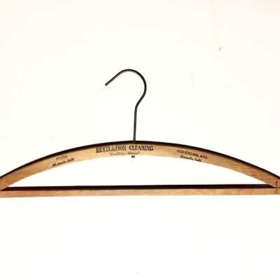 Wooden advertising hanger for Revelation Cleaners, prior 1970