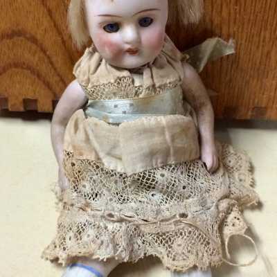 All bisque doll with homemade lace dress with blue silk sash, c. 1910-1912