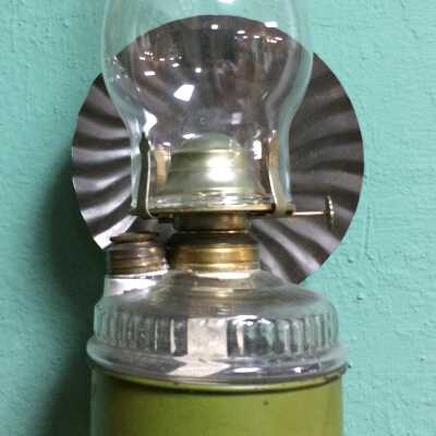Kerosene lamp with brass burner in green painted tin bracket, c. 1900