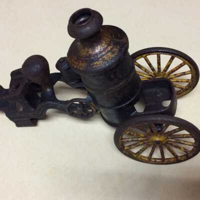 Two-wheel cast iron pumping engine with driver's seat, c. 1900