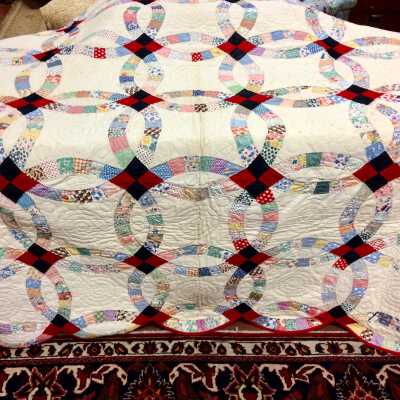 Wedding ring quilt with red trim by Julia Grady, c. 1934