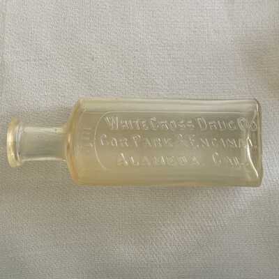 Flat sided medicinal bottle from White Cross Drug Co., c. 1900