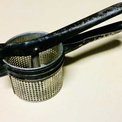 Perforated tin masher with cast iron grip of the Martins, c. 1920s