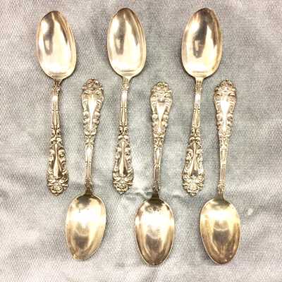 Silver serving spoons with elaborate repousse design on handles, c. 1900