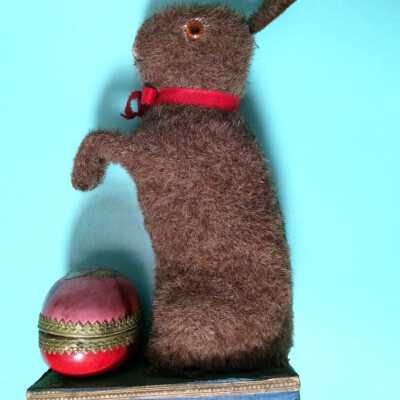 Rabbit and decorated Easter egg attached to squeeze box base, c. 1912