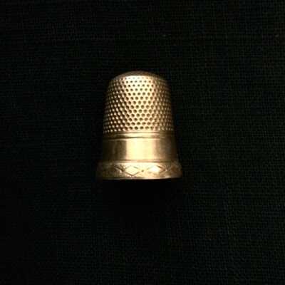 Gold plated thimble with stippled cone and engraved base, late 19th century?