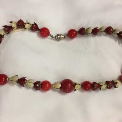 necklace of red plastic beads and metal flowers in white and red enamel, c. 1930s