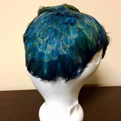 Cocktail hat of dark blue velvet with peacock blue feathers and partial bird, c. 1950s