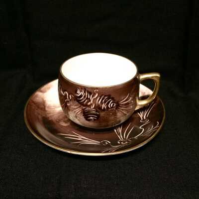 Jorgensen porcelain cup and saucer with a pine cone, c. 1920