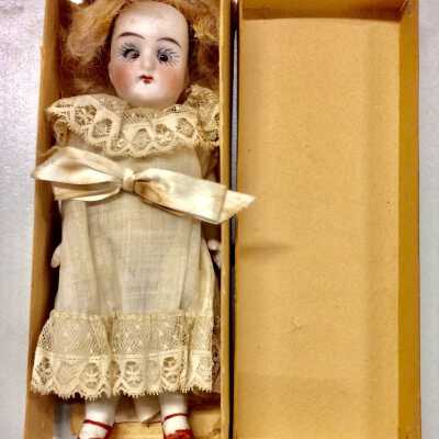 Blond dollhouse doll with white dress in box, of Vera George Knox, early 1900s