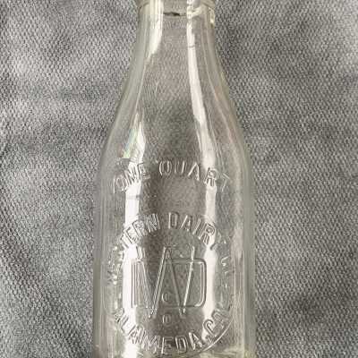 Double-seam clear glass Western Dairy Co. one-quart milk bottle, c. 1920-1930