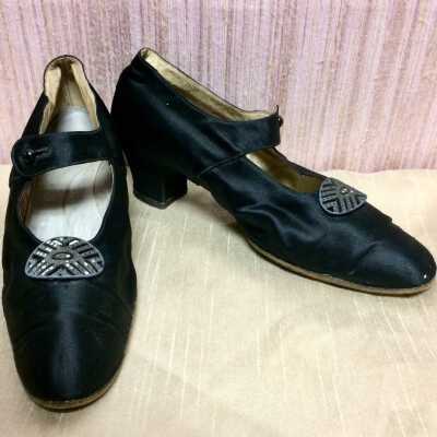 Pair of leather shoes covered in black slipper satin with oval rhinestone buckles, late 1920s-early 1930s