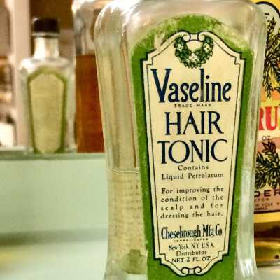 Clear Glass bottle of Vaseline Hair Tonic of the Jordan family