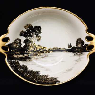 China bowl with painted scene of a river and cottages, pre-1921