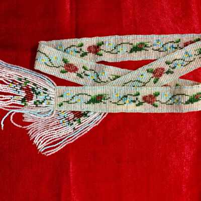 Belt of woven glass beads in flower designs on opalescent background, early 1900s