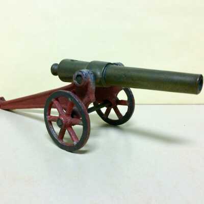 Red Toy Brass Cannon on wheels, early 1900s