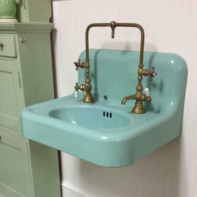 Pale Green enameled iron wall-mounted sink with brass faucets and porcelain handles, 1930s