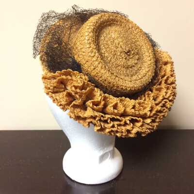 Gold colored straw hat with self-ruched brim and black netting, c. 1940s