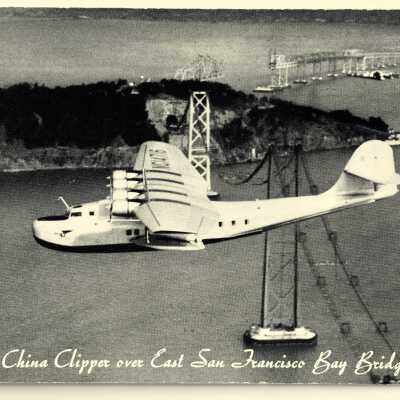 Postcard of Aerial view of China Clipper flying over Bay Bridge, c. 1930s