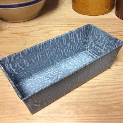 Grey and black mottled enamel loaf pan from a Jackson Street basement, c. 1920s