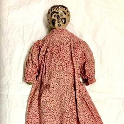 German tin head doll in red dress from 2849 Jackson St, c. 1890s