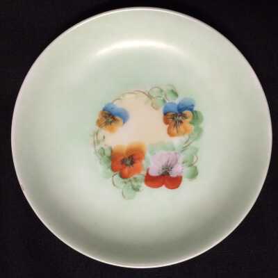 Porcelain saucer handpainted with pansies by Jorgensen, c. 1920s
