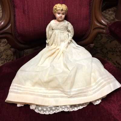 Blue-eyed blond tin head doll with kid body and bisque hands, early 1900s