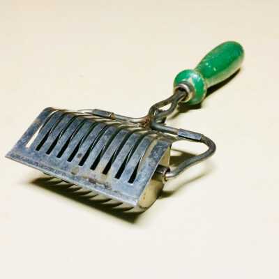 Nickel-plated meat tenderizer with green handle, c. 1920s-1930s