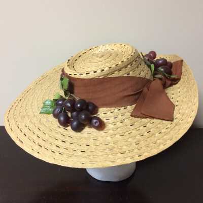 Wide brim hat of open weave straw with ribbon and plastic grapes, 1940s