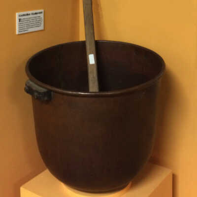 Copper boiler and wooden paddle to heat molasses, from a Hynes concession, Neptune Beach, 1920s-1930s